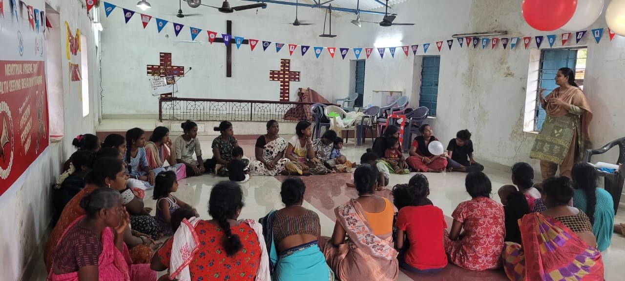 Women listening with rapt attention to period education in Malayadi Nagar